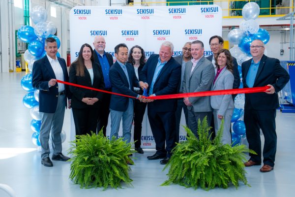 Group of people cutting the ribbon at an event
