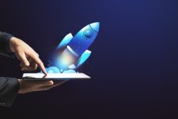Hand selecting button on a tablet to launch a website